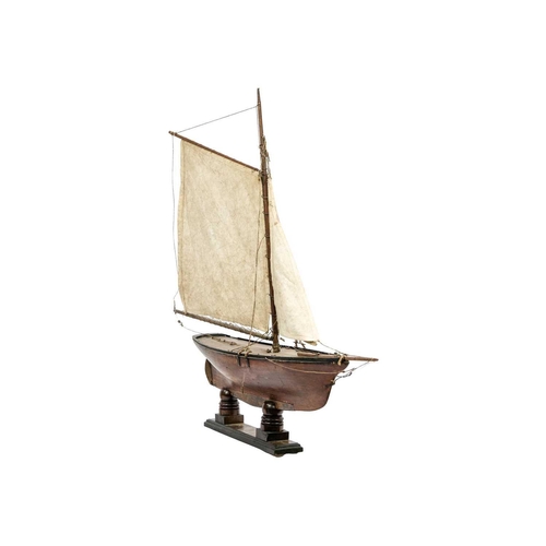133 - A 19th century pond yacht. With authentic rigging and mahogany stand, height 85cm.