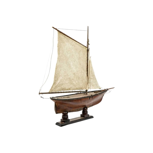 133 - A 19th century pond yacht. With authentic rigging and mahogany stand, height 85cm.