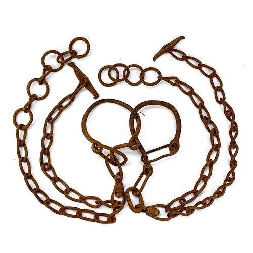 139 - An iron horse tether chain. Together with a pair of livestock hobbles and bull leader. (3)