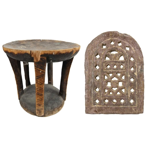 145 - A carved and pierced stone screen & an African stool. The property of Peter Hone. The screen 33cm x ... 