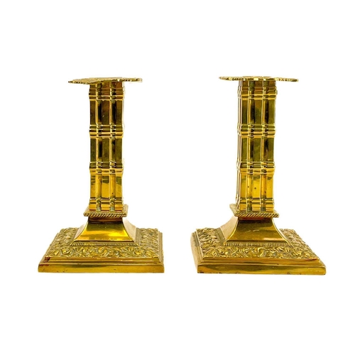 152 - A pair of Victorian brass candlesticks by William Tonks & Sons. With dolphin and flower decoration a... 