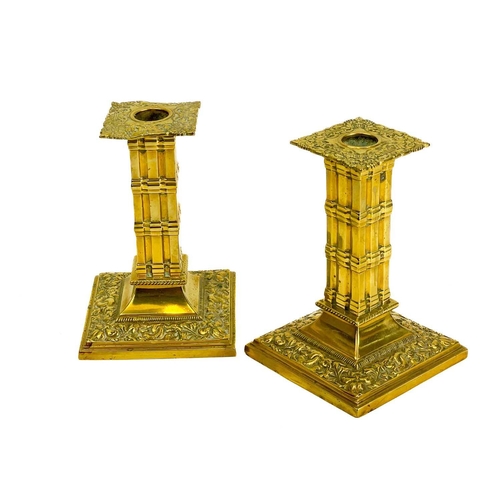 152 - A pair of Victorian brass candlesticks by William Tonks & Sons. With dolphin and flower decoration a... 