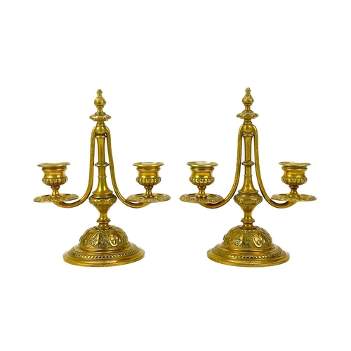 153 - A pair of Victorian brass chambersticks. Ornately decorated with lion paw feet, together with three ... 