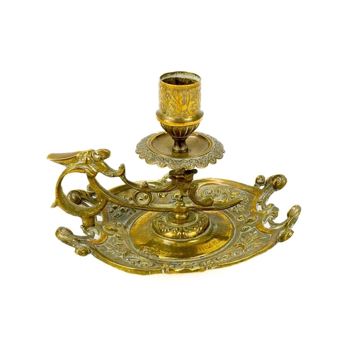 153 - A pair of Victorian brass chambersticks. Ornately decorated with lion paw feet, together with three ... 