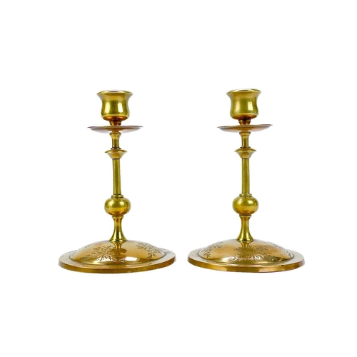 153 - A pair of Victorian brass chambersticks. Ornately decorated with lion paw feet, together with three ... 