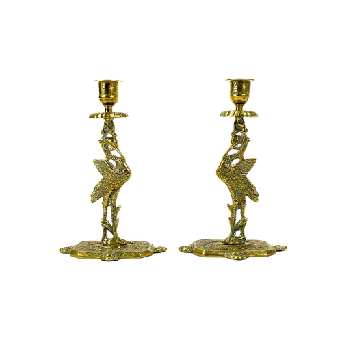 153 - A pair of Victorian brass chambersticks. Ornately decorated with lion paw feet, together with three ... 
