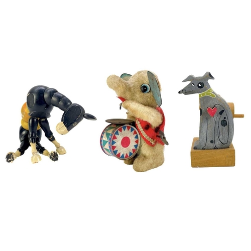 157 - A carved wood automaton in the form of a seated whipped with 'beating' heart. Height 13cm, together ... 