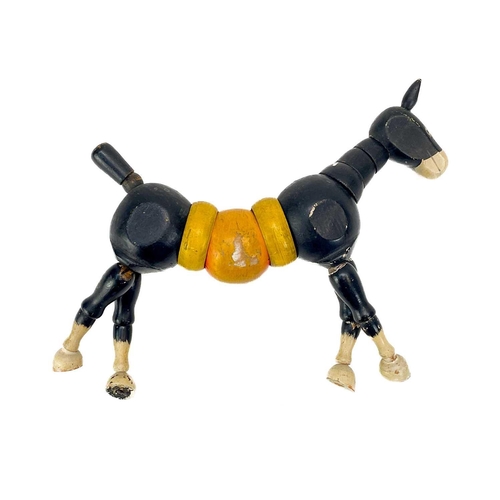 157 - A carved wood automaton in the form of a seated whipped with 'beating' heart. Height 13cm, together ... 