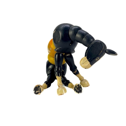 157 - A carved wood automaton in the form of a seated whipped with 'beating' heart. Height 13cm, together ... 