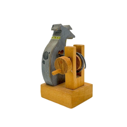 157 - A carved wood automaton in the form of a seated whipped with 'beating' heart. Height 13cm, together ... 