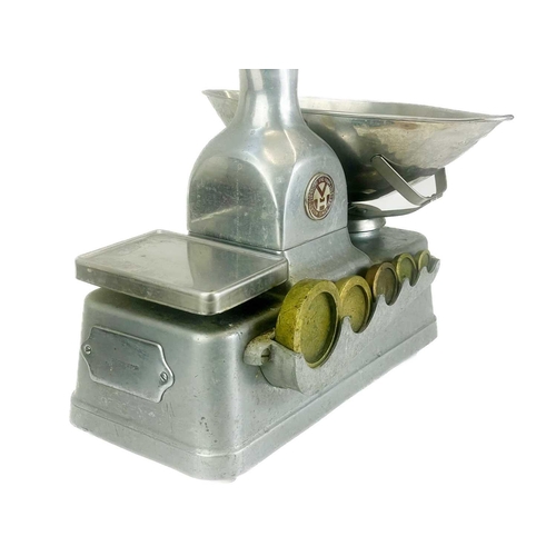 158 - A set of Vandome and Hart Ltd of London aluminium shop scales. With five weights. Height 46cm.