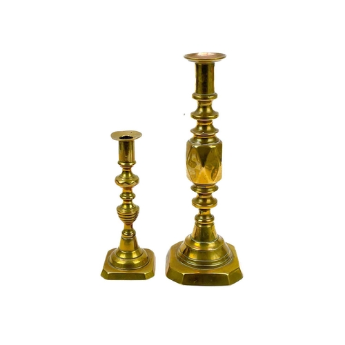 162 - An 18th century brass candlestick with petal base. Height 20cm together with eight other single cand... 