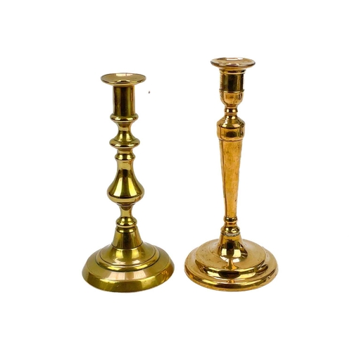 162 - An 18th century brass candlestick with petal base. Height 20cm together with eight other single cand... 