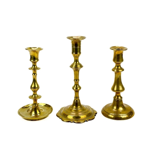 162 - An 18th century brass candlestick with petal base. Height 20cm together with eight other single cand... 