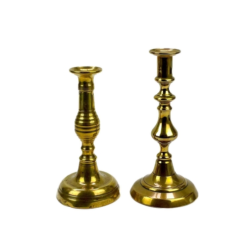 162 - An 18th century brass candlestick with petal base. Height 20cm together with eight other single cand... 