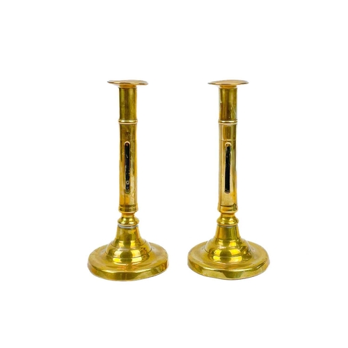 166 - A pair of 18th century brass ejector candlesticks. Height 21cm together with five pairs of brass can... 