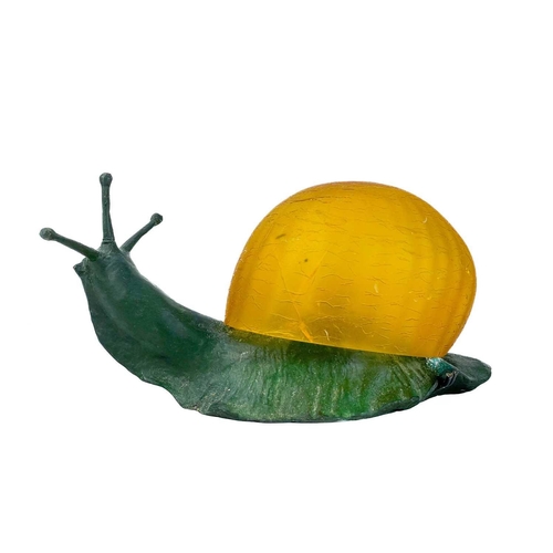 169 - A novelty table lamp in the form of a snail. The simulated bronze body surmounted by an amber glass ... 