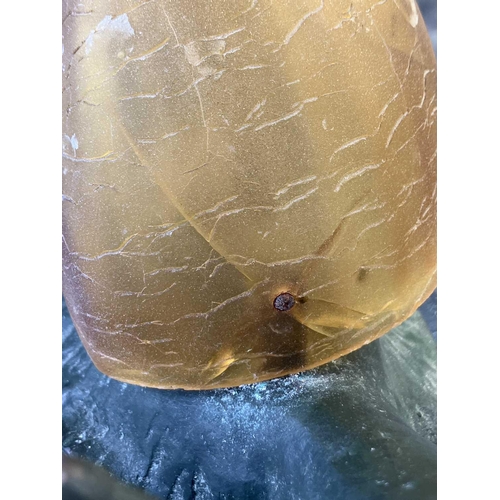 169 - A novelty table lamp in the form of a snail. The simulated bronze body surmounted by an amber glass ... 