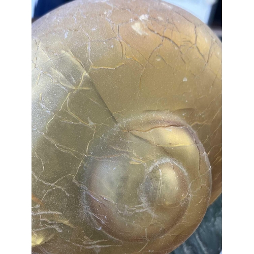 169 - A novelty table lamp in the form of a snail. The simulated bronze body surmounted by an amber glass ... 