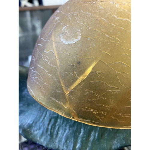 169 - A novelty table lamp in the form of a snail. The simulated bronze body surmounted by an amber glass ... 