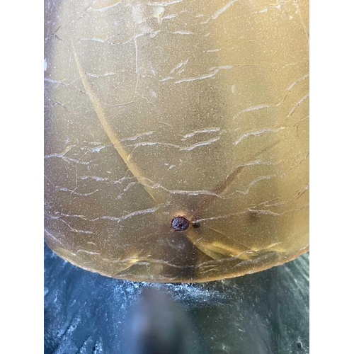 169 - A novelty table lamp in the form of a snail. The simulated bronze body surmounted by an amber glass ... 