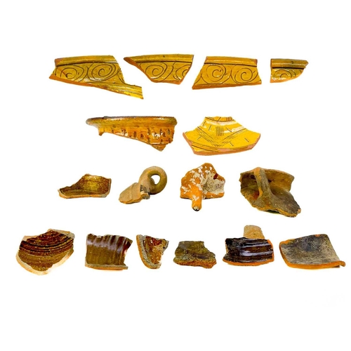 173 - A collection of post Medieval and later pottery shards. Some with incised decoration, one piece appe... 