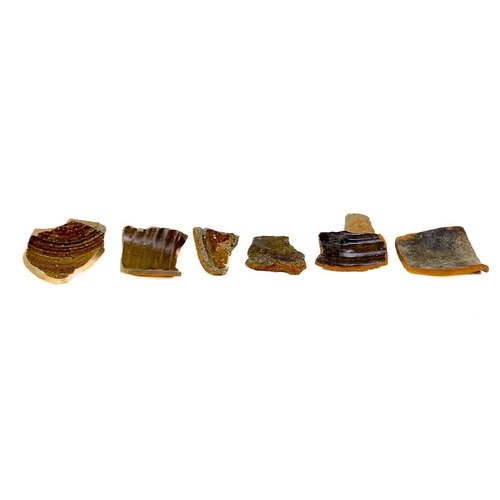 173 - A collection of post Medieval and later pottery shards. Some with incised decoration, one piece appe... 