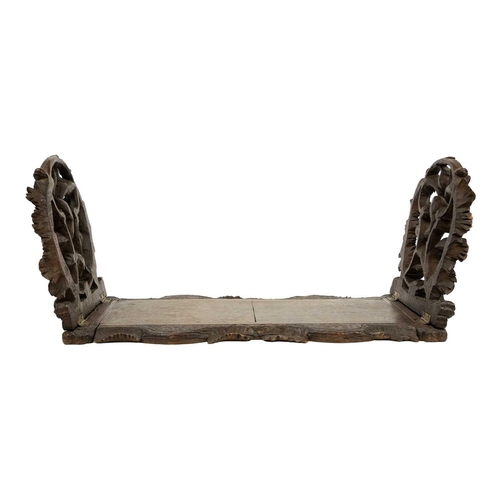 174 - A late 19th century Black Forest book slide. The pierced carved ends decorated with fern leaves and ... 