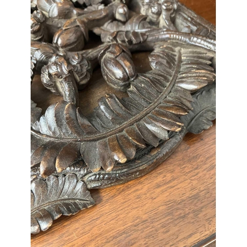 174 - A late 19th century Black Forest book slide. The pierced carved ends decorated with fern leaves and ... 