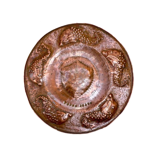 175 - A Cornish Arts and Crafts circular copper tray. By the Eustace brothers of Hayle, the centre decorat... 