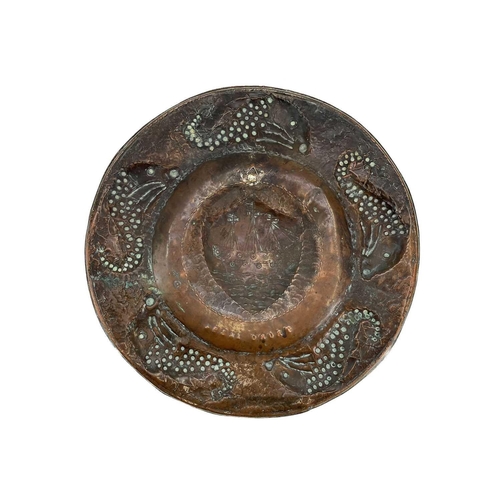 175 - A Cornish Arts and Crafts circular copper tray. By the Eustace brothers of Hayle, the centre decorat... 
