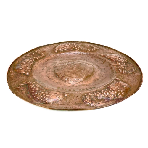 175 - A Cornish Arts and Crafts circular copper tray. By the Eustace brothers of Hayle, the centre decorat... 