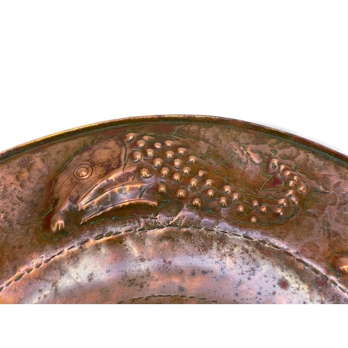175 - A Cornish Arts and Crafts circular copper tray. By the Eustace brothers of Hayle, the centre decorat... 
