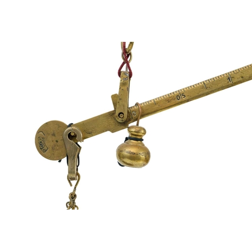 176 - An early 20th century brass balance scales Marked MDVC, height 50cm.