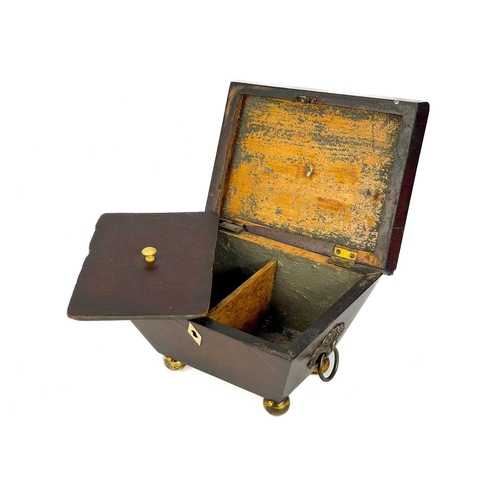 180 - A George III mahogany sarcophagus tea caddy. With twin brass cornicopia handles on brass ball feet. ... 