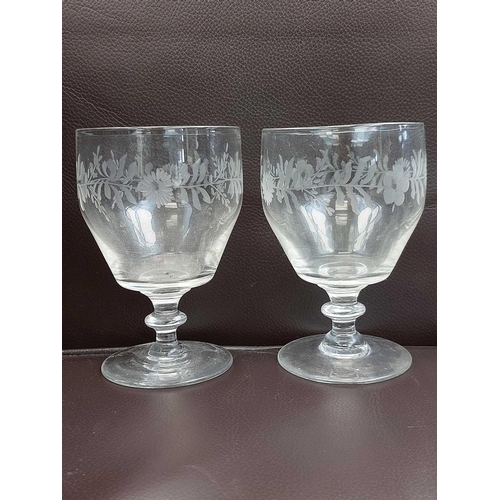 359 - A set of four 19th century English glass rummers. Engraved with flowers, height 12cm together with o... 