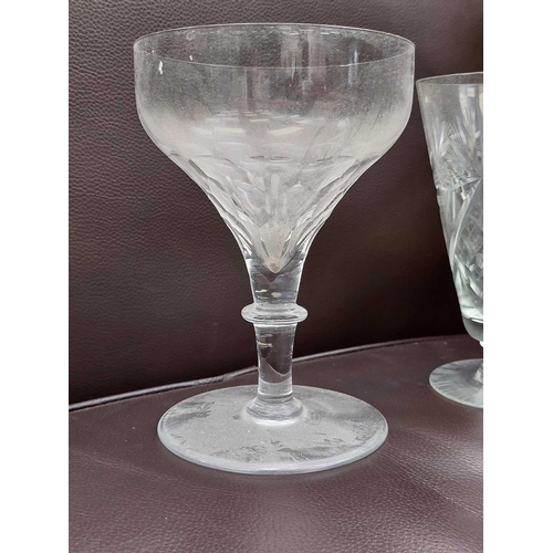 359 - A set of four 19th century English glass rummers. Engraved with flowers, height 12cm together with o... 