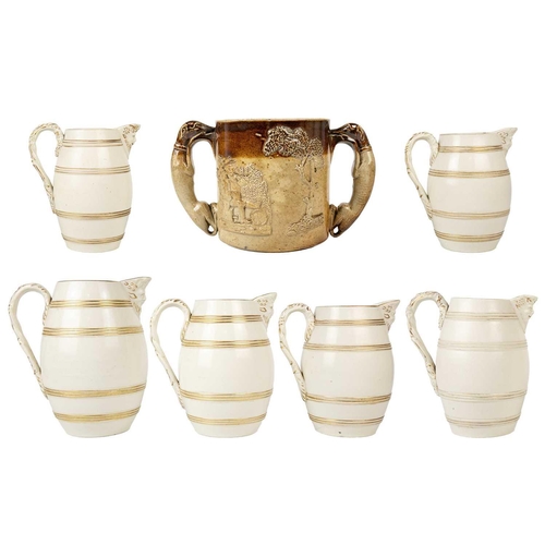 360 - A set of six 19th century English porcelain barrel mask jugs. Tallest 19.5cm together with a twin ha... 
