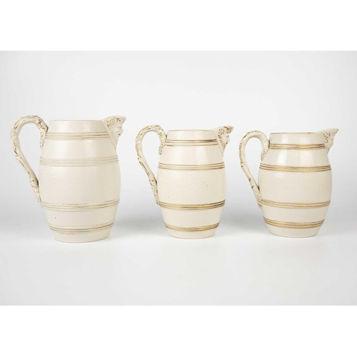 360 - A set of six 19th century English porcelain barrel mask jugs. Tallest 19.5cm together with a twin ha... 