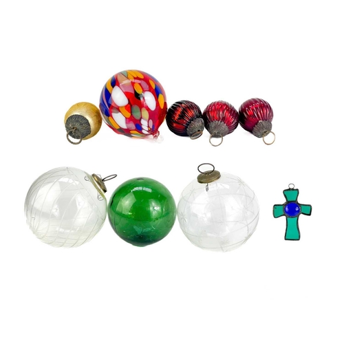373 - A collection of glass hanging balls. In various sizes and colours. The largest measures 14cm in diam... 