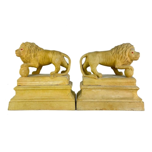 377 - A pair of early 20th century terracotta Medici lions. Raised on plinth bases indistinctly signed and... 