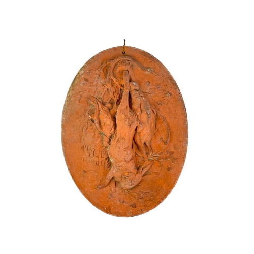 378 - A late 19th century French terracotta oval plaque. Decorated with game hanging from an oak tree, imp... 