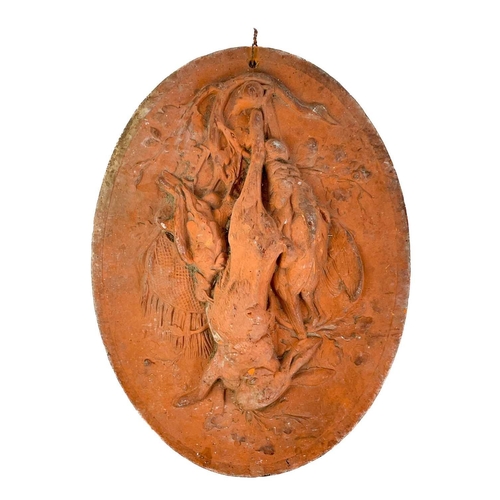 378 - A late 19th century French terracotta oval plaque. Decorated with game hanging from an oak tree, imp... 