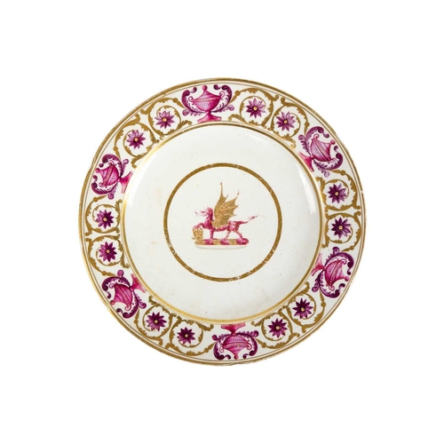 386 - A 19th century armorial plate. The centre painted with a dragon passant, within borders decorated wi... 