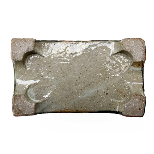 395 - A Bristol blue pig money box. Height 7cm together with a studio pottery flower brick. (2)