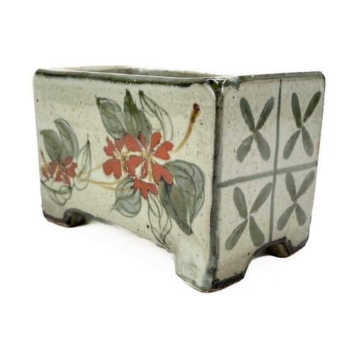 395 - A Bristol blue pig money box. Height 7cm together with a studio pottery flower brick. (2)