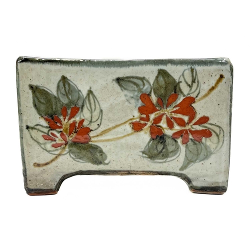 395 - A Bristol blue pig money box. Height 7cm together with a studio pottery flower brick. (2)