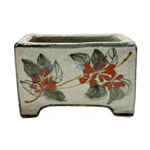 395 - A Bristol blue pig money box. Height 7cm together with a studio pottery flower brick. (2)