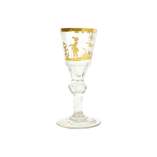 408 - A Bohemian gilt decorated wine glass. Circa 1780, the panelled tapered bowl with a gilt rim, and pai... 