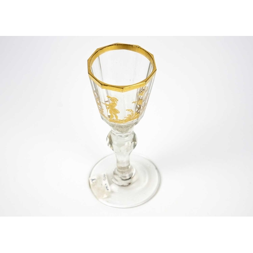 408 - A Bohemian gilt decorated wine glass. Circa 1780, the panelled tapered bowl with a gilt rim, and pai... 